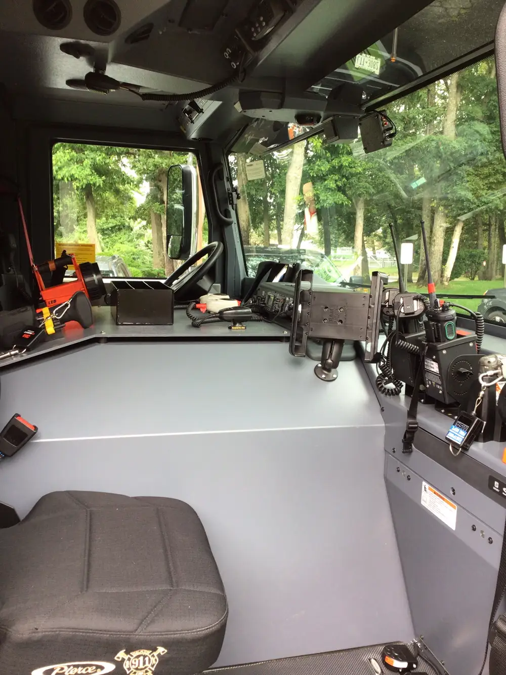 Rear-right exterior view with open compartments and rear ladder