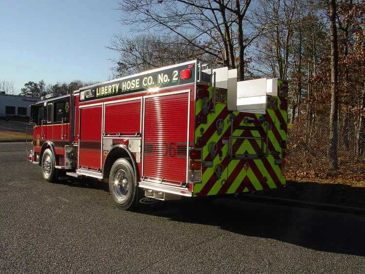 Rear-right exterior view showing rear chevrons, side compartments, and rear wheel