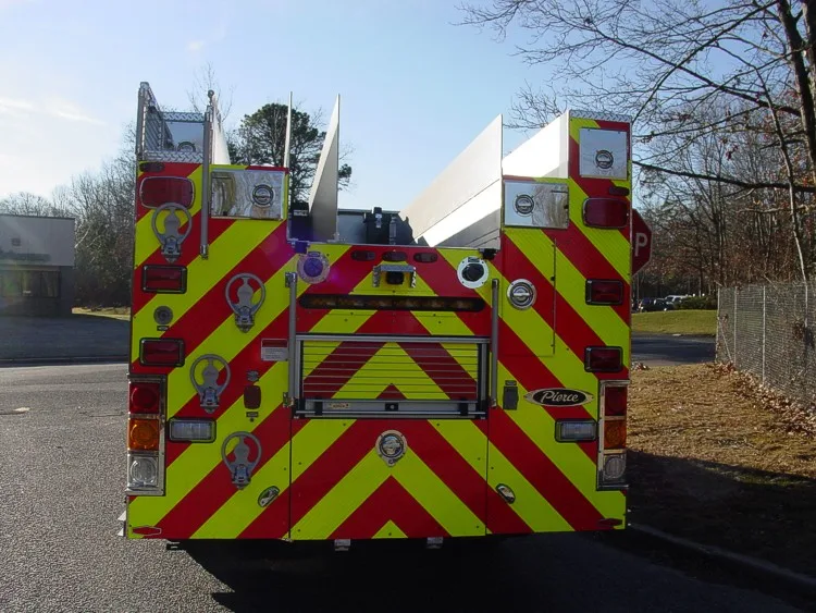 Rear view showing chevron striping, rear body panel, and hosebed opening