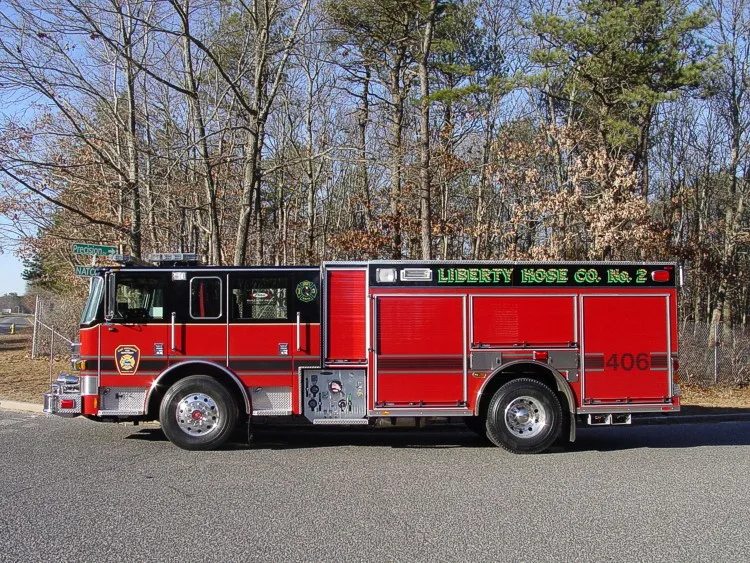 Driver-side profile view showing compartments, wheel area, and cab