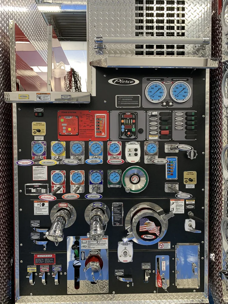 Pump panel close-up showing gauges, valves, and intake controls