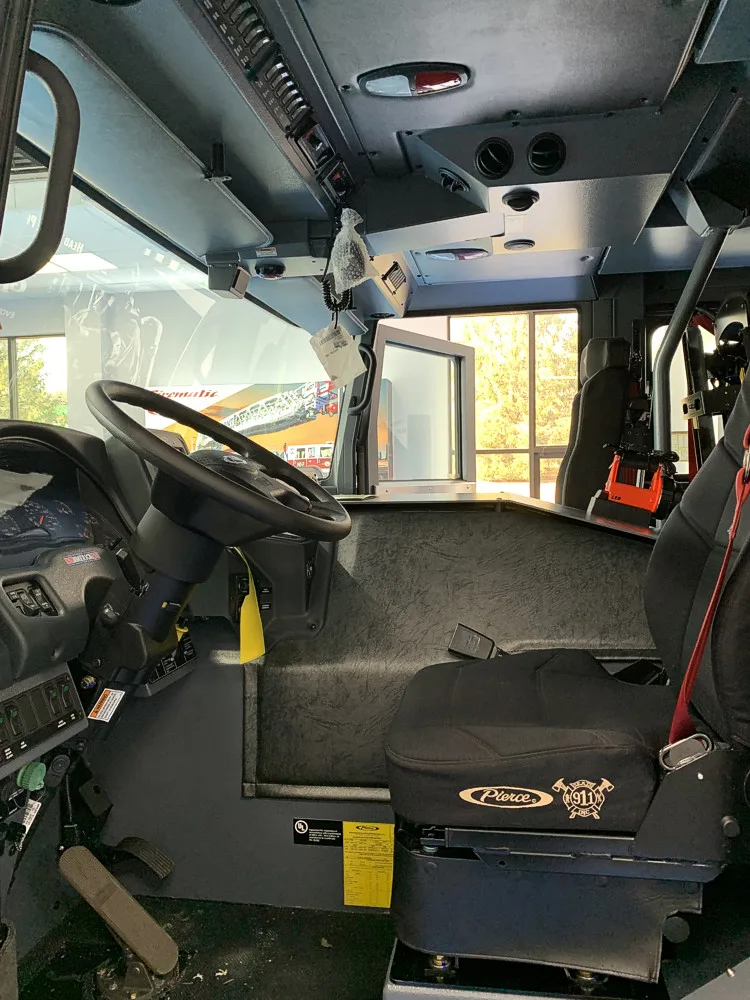 Cab interior side view showing rear seats and overhead controls