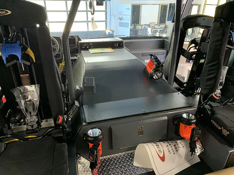 Cab interior side view showing front seats and center console