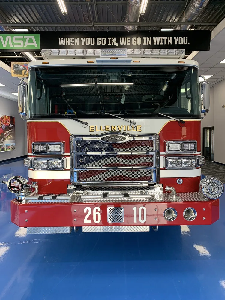 Head-on front view showing grille, bumper, and warning lights