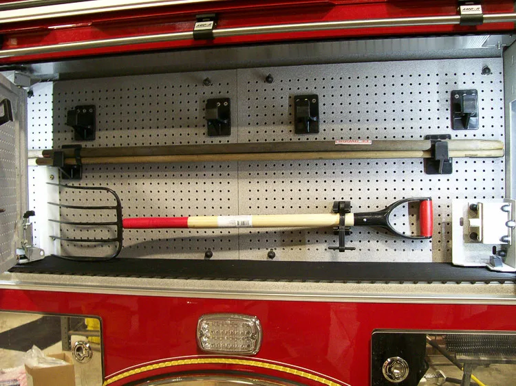 Open side compartment showing mounted hand tools and storage pegs