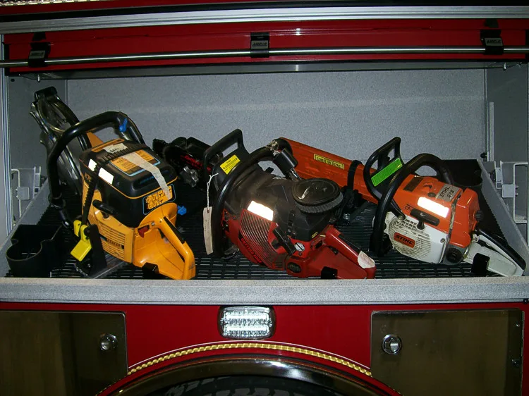 Open side compartment showing chainsaws and power rescue tools