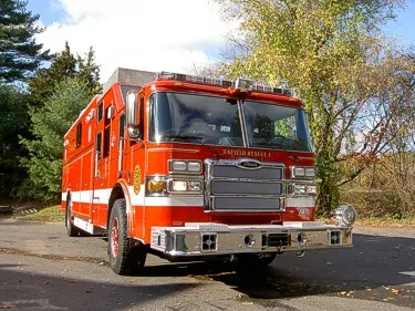 Front-left low-angle view showing grille, bumper, and rescue body height