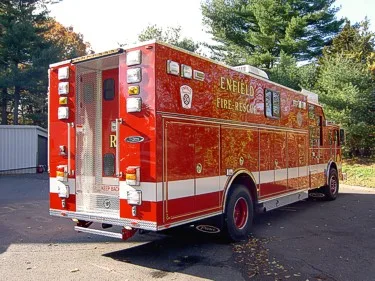 Rear-right exterior view showing rear door area and side panel lettering