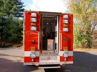 Rear view with back doors open showing pass-through rear entry compartment