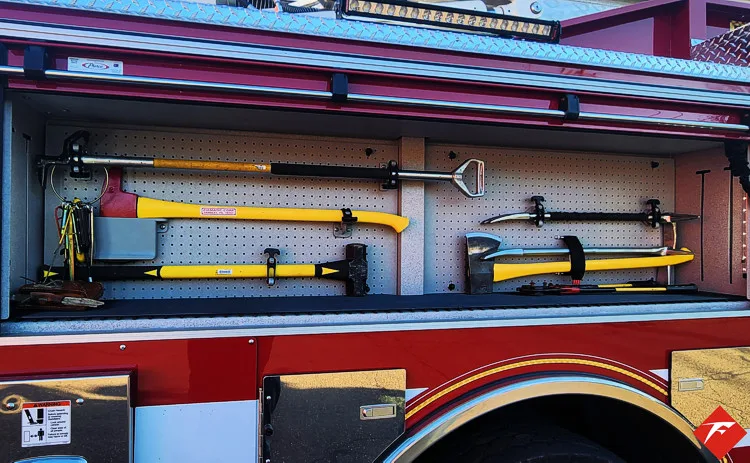 Open side compartment showing hand tools mounted in horizontal rack