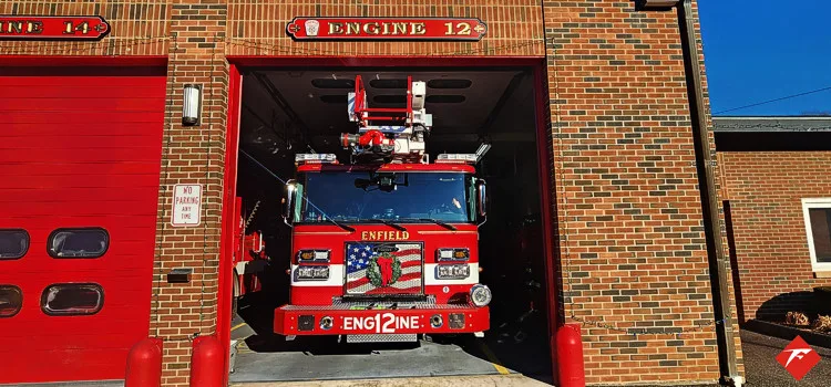 Front view inside bay showing grille, bumper, and warning lights