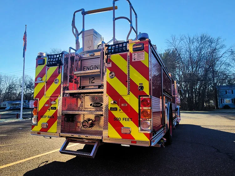 Rear view showing red-and-yellow chevrons and ladder base assembly