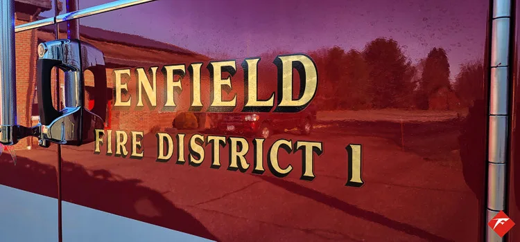 Cab door close-up showing department lettering on red paint