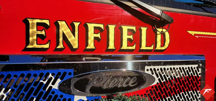 Front grille close-up showing raised department script and chrome mesh