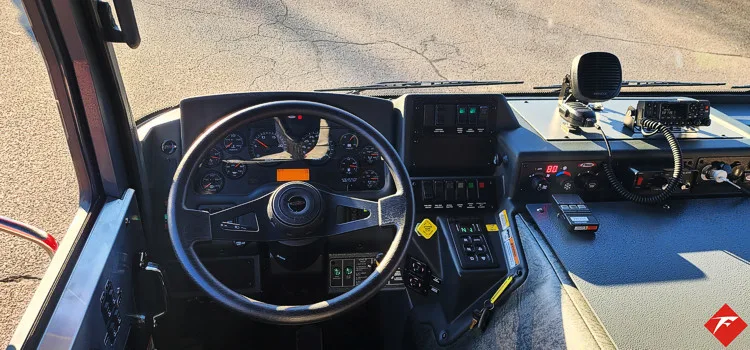 Driver cockpit view showing steering wheel, dashboard, and center controls