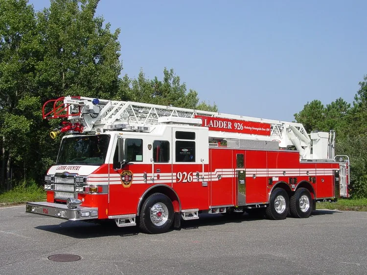 Front-right wide exterior view showing the cab, side compartments, front outrigger, and ladder bed.
