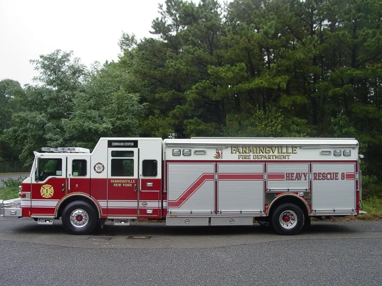 Full right-side profile of the heavy rescue body with multiple roll-up compartments and command-cab windows.