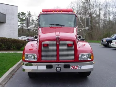 Head-on front view showing grille, bumper, and warning lights
