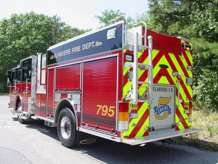 Rear right angle showing chevron-striped back, side compartment doors, and rear access ladder.