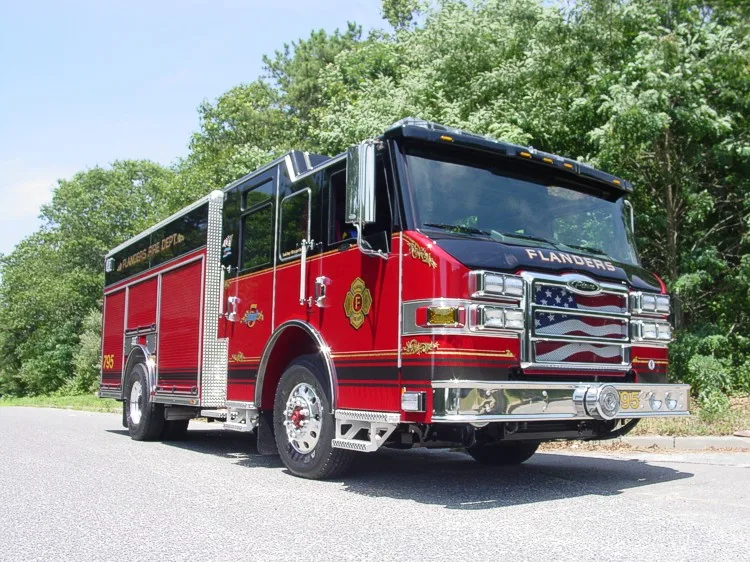 Front right exterior view highlighting cab roof lights, grille, and right-side body compartments.
