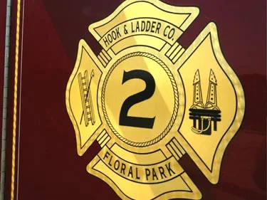 Close-up of gold shield logo on maroon side panel