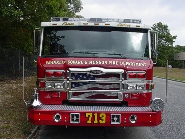Front exterior view showing grille, bumper, and warning lights