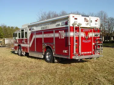 Rear-right exterior view showing heavy rescue rear panel and side striping