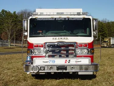 Head-on front view showing grille, bumper, and windshield banner text