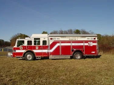Passenger-side full profile showing rescue body, side compartments, and wheel layout