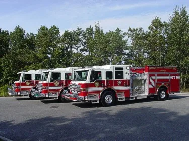 Front-left lineup view showing similar pumpers parked in row