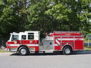Driver-side profile view showing pumper body and rear wheel area