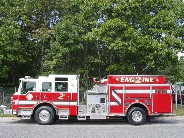 Driver-side full profile showing pumper body and side panel striping