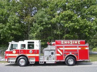 Driver-side profile showing pumper body and side stripe pattern