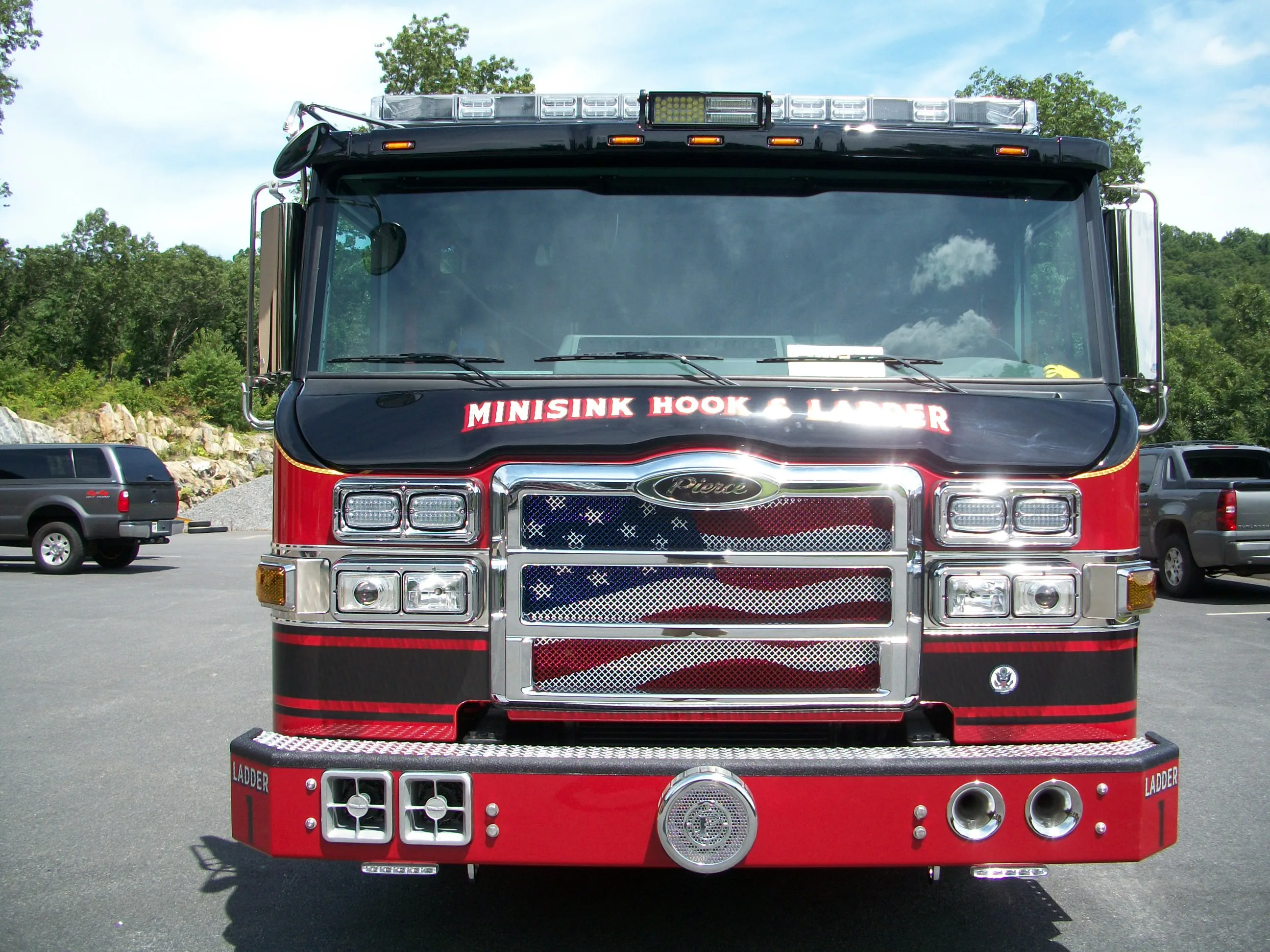 Head-on front view showing grille, windshield, warning lights, and front bumper intake fittings.