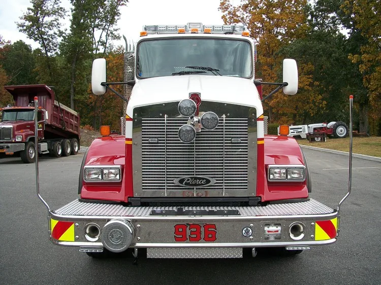 Head-on front view showing the grille, bumper-mounted intake area, warning lights, and mirrors.