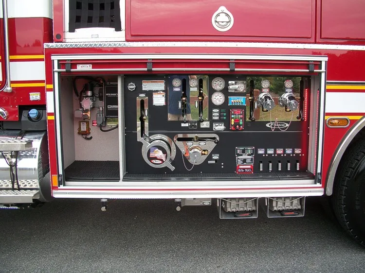 Pump panel close-up showing gauges, levers, intake controls, and surrounding diamond-plate trim.
