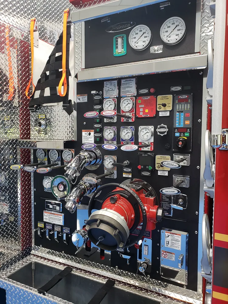 Pump panel close-up showing gauges, valves, and intake hardware