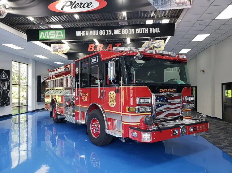 Pumper front-left exterior view showing cab and side body in station bay