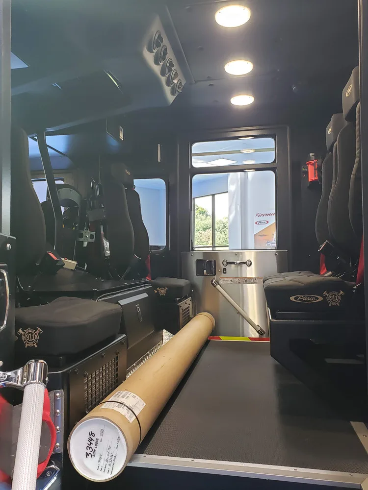 Crew cab interior view showing seat row and side wall equipment mounts