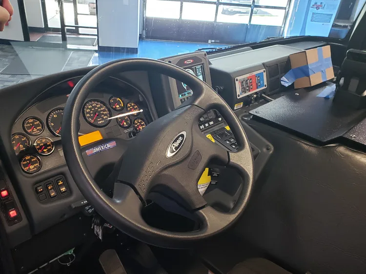 Driver cockpit view showing steering wheel, dashboard, and center console
