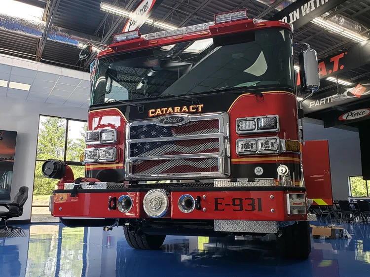 Head-on front view showing grille, warning lights, and bumper intakes