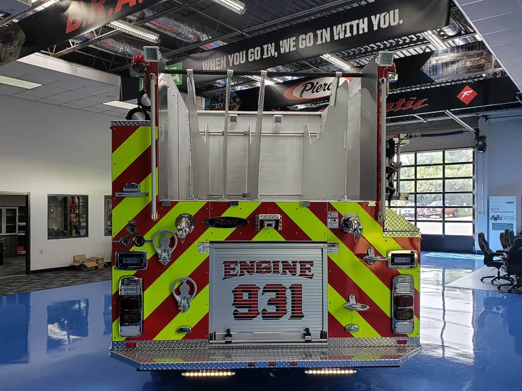 Rear view showing red-and-yellow chevrons and unit lettering panel