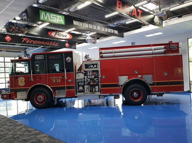 Driver-side full profile showing pumper body and rear wheel area