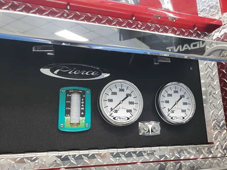 Gauge panel close-up showing dual pressure gauges in black bezel