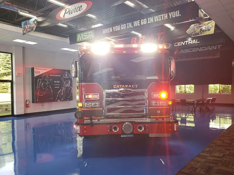 Head-on front view with emergency lights illuminated in apparatus bay