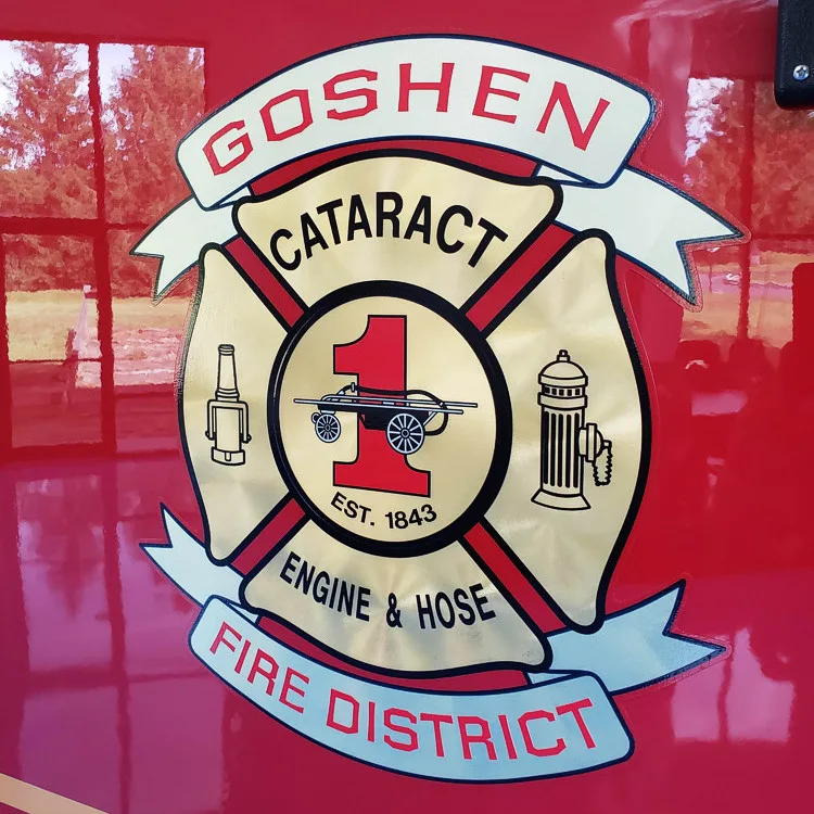 Cab door close-up showing circular department crest on red panel