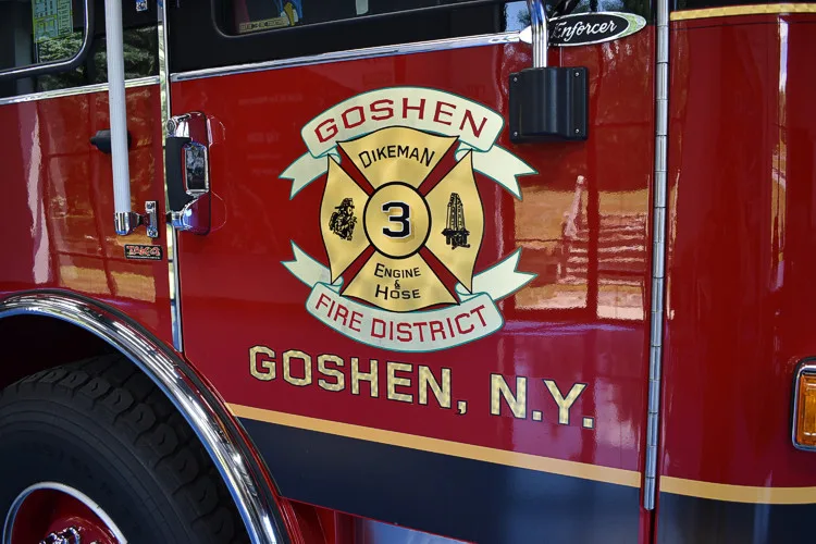 Cab door close-up showing department crest on red panel