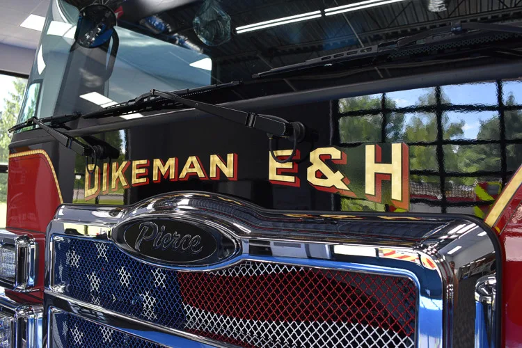 Front grille close-up showing company lettering and Pierce badge