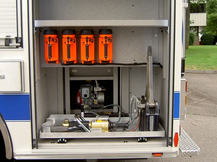 Open side compartment showing mounted flashlights and equipment tray