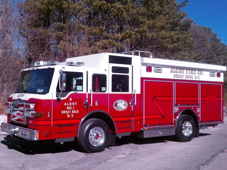 Driver-side angled profile showing the side compartments, cab doors, and front bumper details.